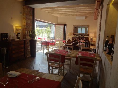 a restaurant with tables and chairs with wine glasses at Hotel Noce in Brescia