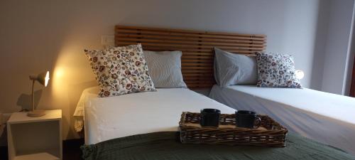 twee bedden in een slaapkamer met een mand op het bed bij "LAGO VERDE" Como garage privato in Como