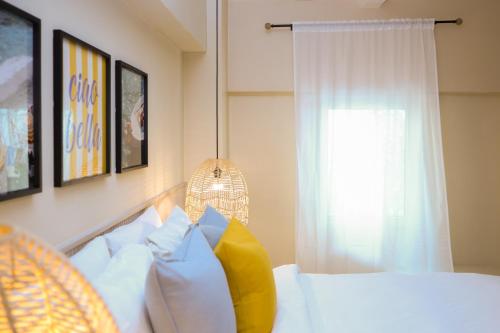 a bedroom with a white bed and a window at Magnolia Inn in Panama City
