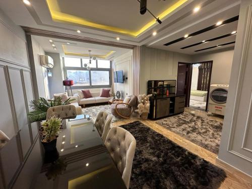 a large living room with a table and chairs at Elegant SeaView Apartment in Alexandria