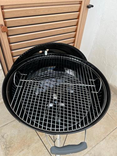 a black grill sitting on top of a table at L'angolo di Jana in Porto Pollo