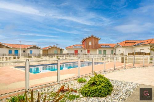 - une piscine dans un complexe avec des maisons dans l'établissement Biscarrosse Plage Maison avec piscine collective à 100m des plages pour 6 personnes, à Biscarrosse