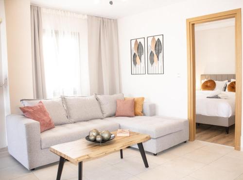 a living room with a couch and a table at Zen Beachfront Apartment in Kokkíni Khánion