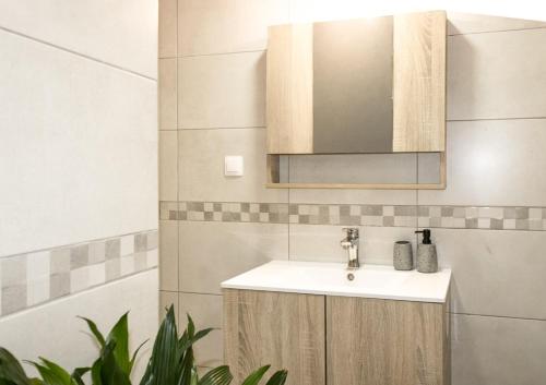 a bathroom with a sink and a mirror at Zen Beachfront Apartment in Kokkíni Khánion