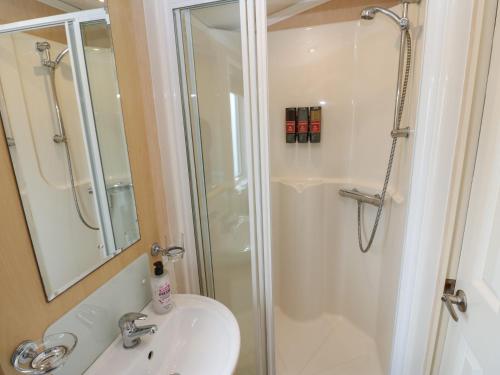 a bathroom with a shower and a sink and a shower at New Horizon in Carlisle