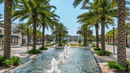 a fountain in a park with palm trees at Seacrest Townhomes 7 - Sol and Sea in Seacrest