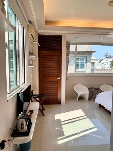 a bedroom with a bed and a television in a room at 潔坊琳居民宿 JayLin Home in Yuchi