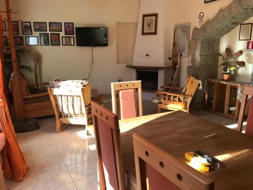 a living room with a wooden table and chairs at Agri Grotta dell'Eremita in Castelmezzano