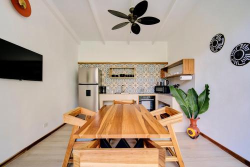 a kitchen with a wooden table in a room at Villas Roca del Caribe in Puerto Viejo