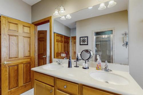 a bathroom with two sinks and a mirror at Reserve 19-D in Sugar Mountain