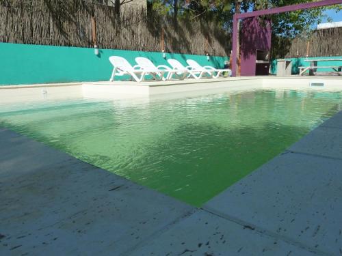 a group of chairs sitting next to a swimming pool at Aguamansa in Las Gaviotas
