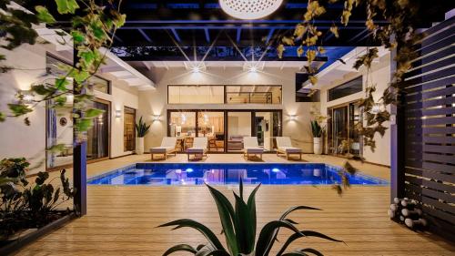 a swimming pool in a house with a house at Villas Roca del Caribe in Puerto Viejo