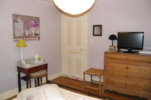 Televízia a/alebo spoločenská miestnosť v ubytovaní Chambre d'hôte Jules & Annette