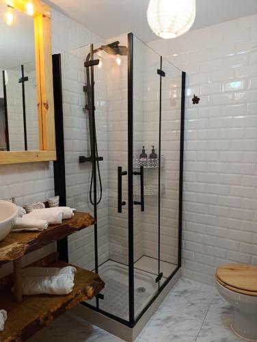 a glass shower in a bathroom with a toilet at HyP - Mar y Descanso in Sotomayor