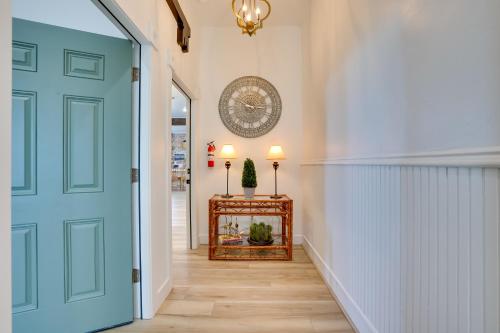 a hallway with a blue door and a table at Walk to Shops and Eats Charming Dtwn Emmett Apt! in Emmett