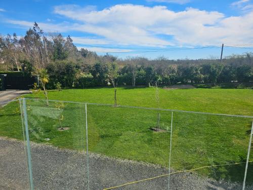 a batting cage with two trees in a field at Contemporary Dublin Suite with hot tub in Lispapple Cross Roads