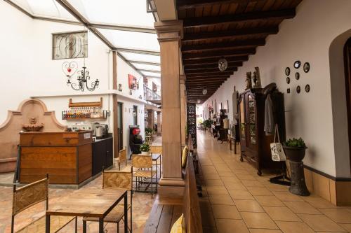 a hallway with tables and chairs in a store at Hotel-Boutique La Casa De Los Recuerdos in Zitácuaro