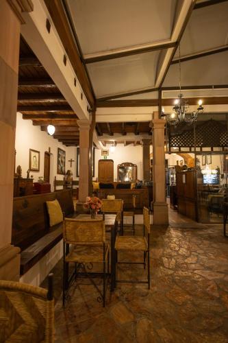 a living room with a table and chairs in a building at Hotel-Boutique La Casa De Los Recuerdos in Zitácuaro