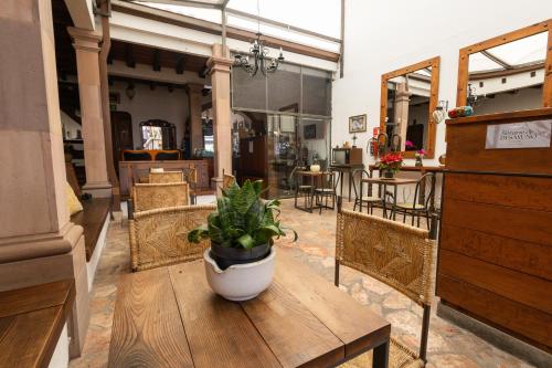 a potted plant sitting on a table in a room at Hotel-Boutique La Casa De Los Recuerdos in Zitácuaro