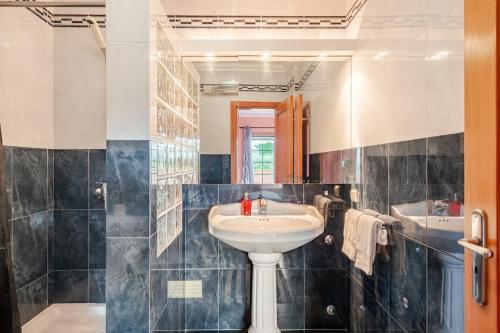 a bathroom with a sink and a mirror at CASA LAVANDA - very nice stylish house in Caldas da Rainha