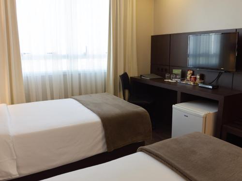 Postel nebo postele na pokoji v ubytování Bourbon Convention Hotel Ponta Grossa