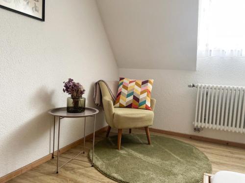 a room with a chair and a table with a pillow at Landhotel Waldheim in Pliezhausen
