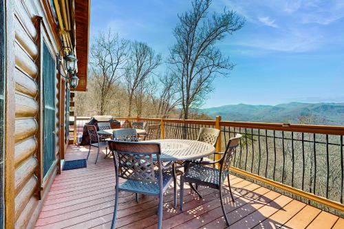 a table and chairs on a deck with a view at Big Sky in Whittier
