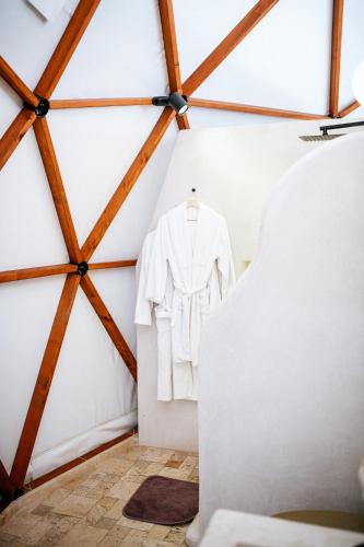 a white shirt hanging on a wall in a room at Mandalin Glamping in Selcuk