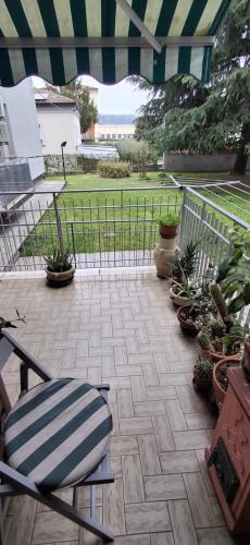 a patio with a chair and a fence and plants at Milva B&B in Casalecchio di Reno
