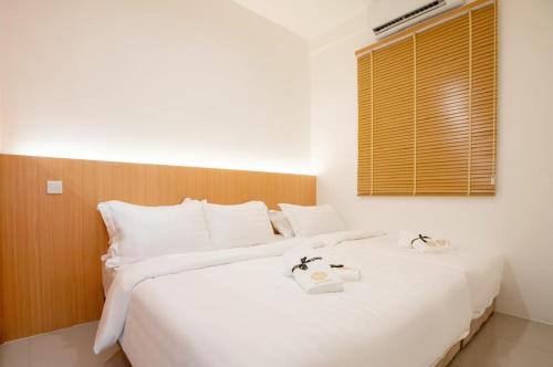 a bedroom with a large white bed and a window at KLIA Residence Homestay Apartment, Near Sepang Circuit and KLIA - 3 Bedroom Fully Aircond in Nilai