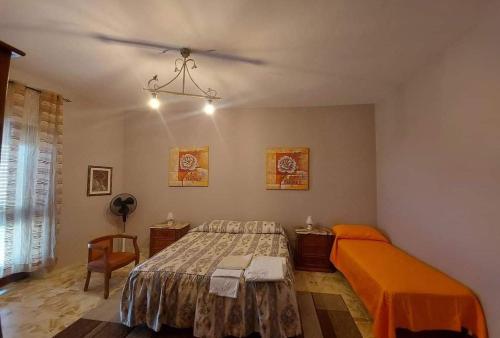 a bedroom with a bed and a chair in it at Torre Adelasia in Aidone