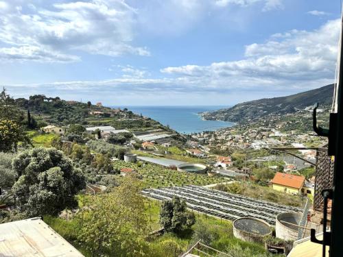 a view of a town with the ocean in the background at Suite Maurixe 34 - Sanremo in Sanremo