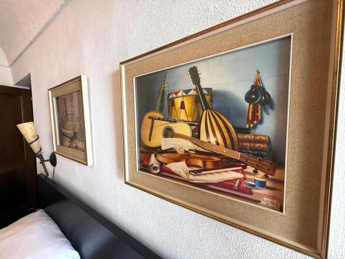a picture of a painting hanging on a wall at Suite Maurixe 34 - Sanremo in Sanremo