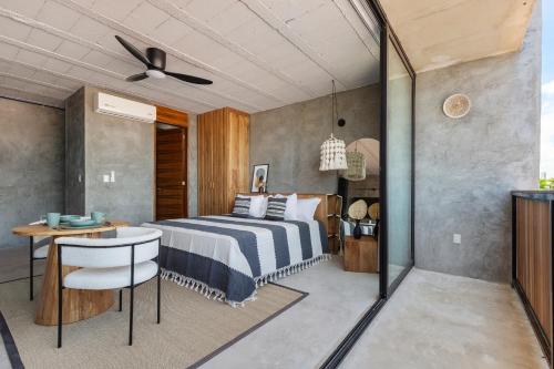 a bedroom with a bed and a table and a chair at Grand Loft with Rooftop Pool in the heart Cancun in Cancún