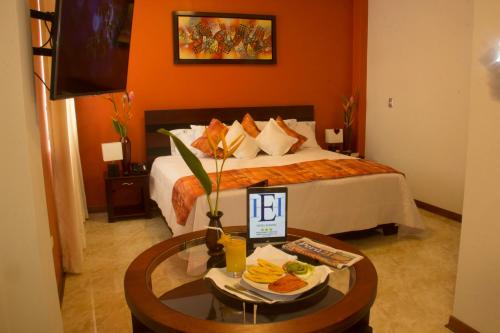 a hotel room with a bed and a table with food on it at Hotel Europa in Iquitos