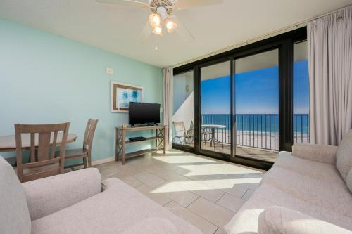 a living room with a view of the ocean at Phoenix All Suites Hotel in Gulf Shores