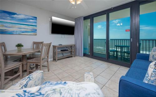 a living room with a view of the ocean at Phoenix All Suites West Hotel in Gulf Shores