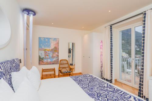 a bedroom with a bed and a large window at Five Positano in Positano