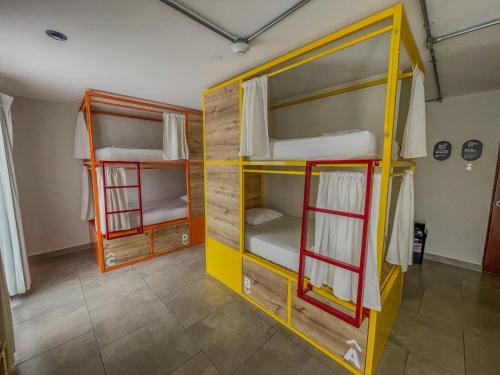 a room with two bunk beds in it at Viajero Huacachina Hostel in Ica