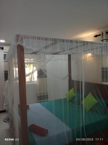 a bedroom with a bed with a canopy at Solace Transit Villa in Katunayake