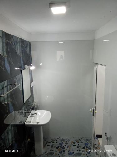 a bathroom with a sink and a mirror at Solace Transit Villa in Katunayake