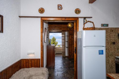 a kitchen with a refrigerator and a hallway at Oropos By the Sea in Markópoulon Oropoú