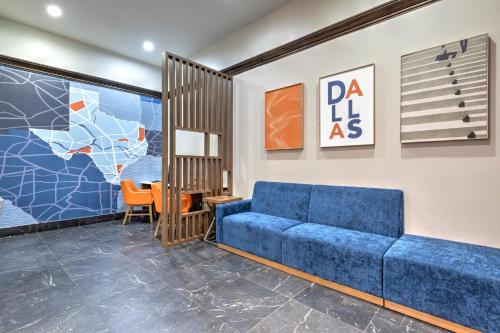 a living room with a blue couch and a table at Holiday Inn Express - Dallas Downtown by IHG in Dallas