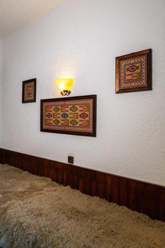 a room with three pictures on the wall at Oropos By the Sea in Markópoulon Oropoú