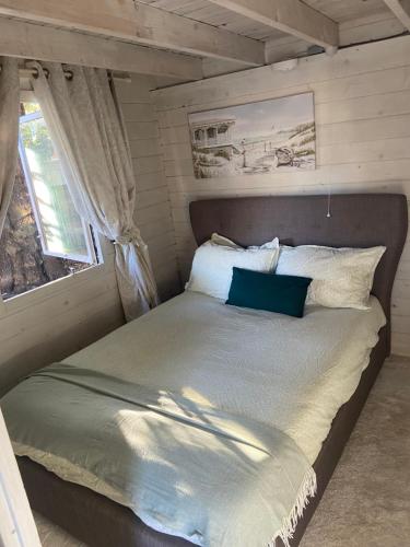 a bed in a small room with a window at Sea breeze lodge mudeford in Burton