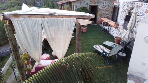 a gazebo with a table and chairs in a yard at Casa Jonay in Hermigua