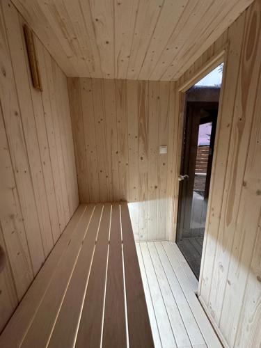 a inside of a wooden sauna with a door at Dom w górach z kominkiem i balią ogrodową Sielanka in Skomielna Czarna