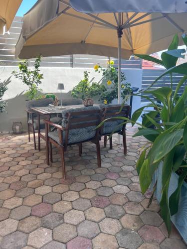 a table and chairs under an umbrella on a patio at Sea Breeze in Kalamaki Chanion