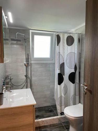 a bathroom with a sink and a shower curtain at Center Twin Apartments - 2 in Chios