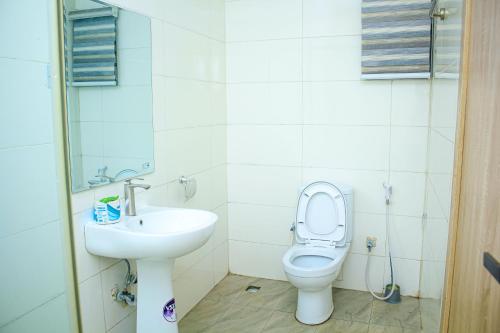 a bathroom with a toilet and a sink at Marquee Land Hotel in Lagos